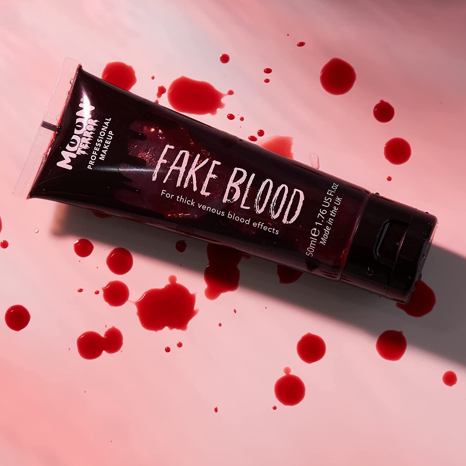 fake blood on pink background with splatters of fake blood. Best cheap fancy dress ideas