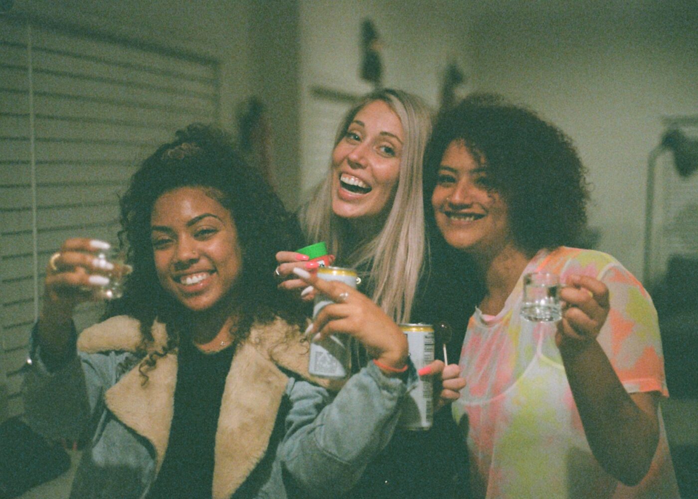 kevin-turcios-uDCU8xA8C4g-unsplash.jpg Female students posing together with drinks during freshers' week