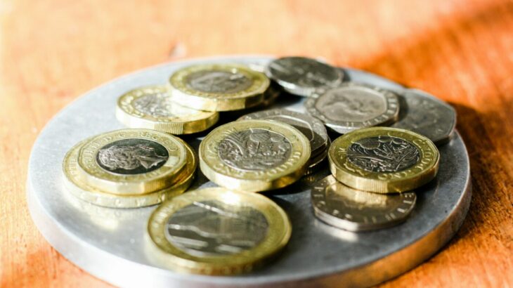 pile-of-pound-coins-student-finance-payment-dates.jpg Pile of coins on a plate - student finance payment dates