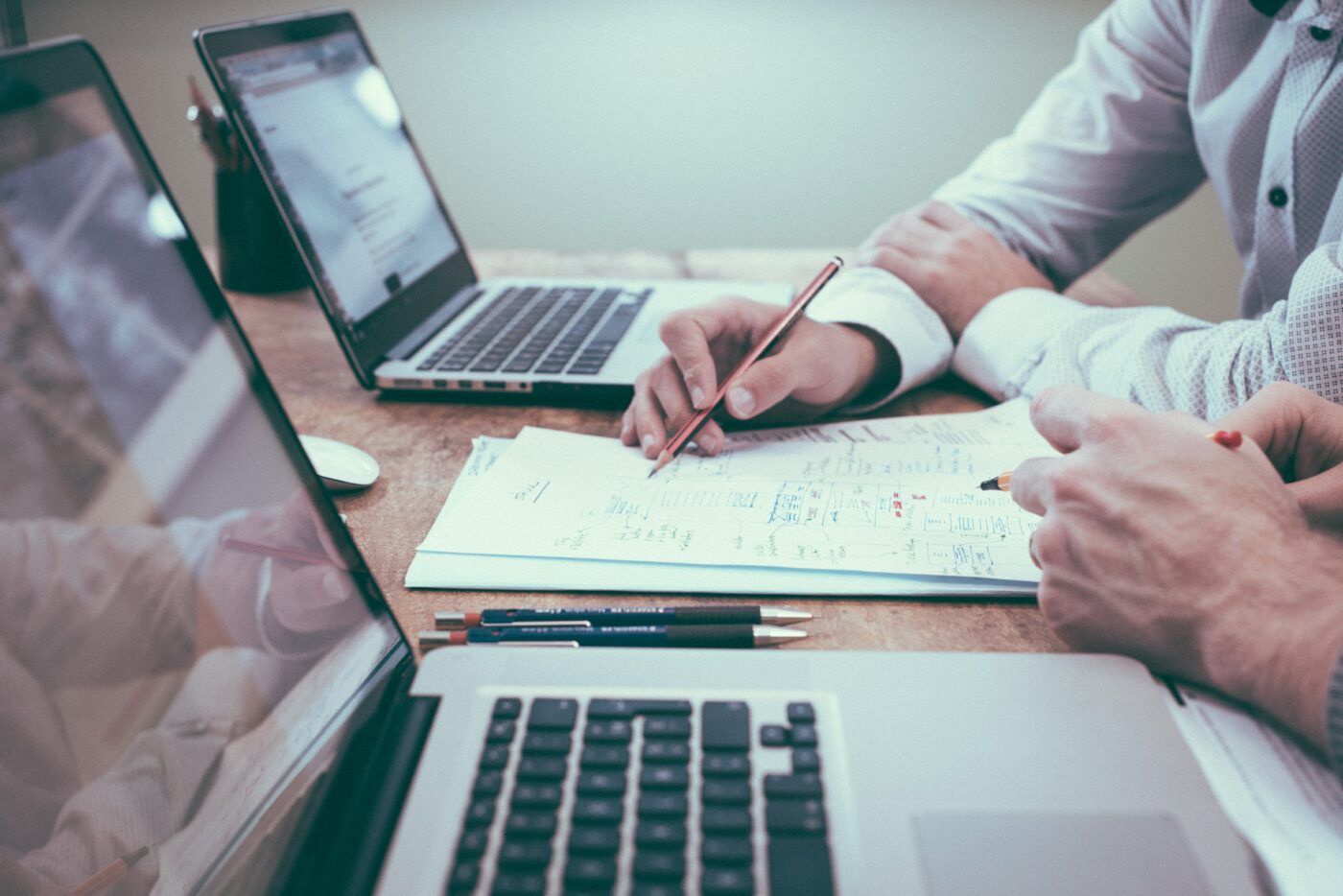 scott-graham-5fNmWej4tAA-unsplash.jpg People sat at two laptops reading through their revision notes